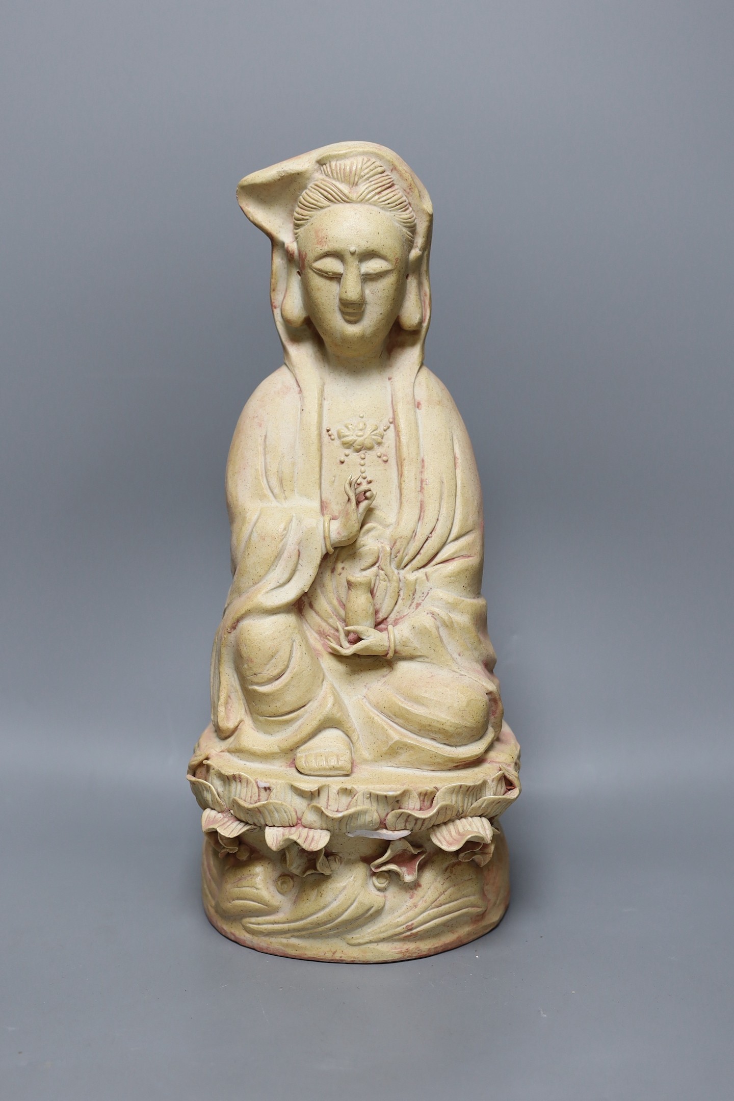 A Chinese biscuit figure of Guanyin, 38 cms high